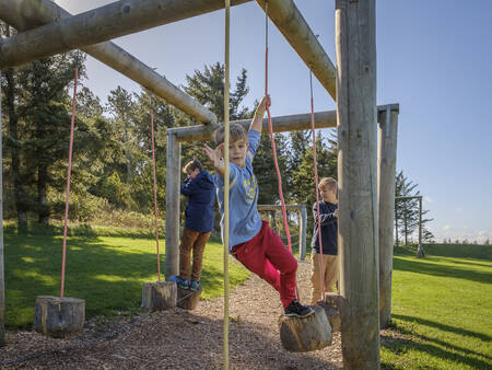 Children play in a playground at Landal Holiday Park Rønbjerg