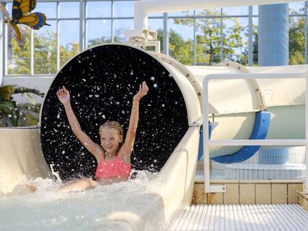 Girl on the slide in the swimming pool of Landal Vakantiepark Søhøjlandet