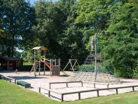 Playground with climbing equipment and a swing at the Landal Landgoed De Elsgraven holiday park