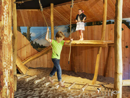 Children play in the indoor playground of holiday park Landal Landgoed 't Loo