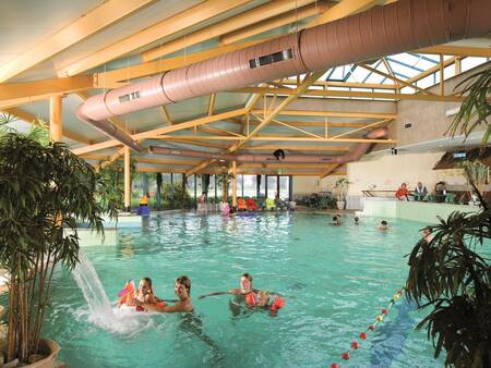 People swim in the indoor pool of holiday park Landal Landgoed 't Loo