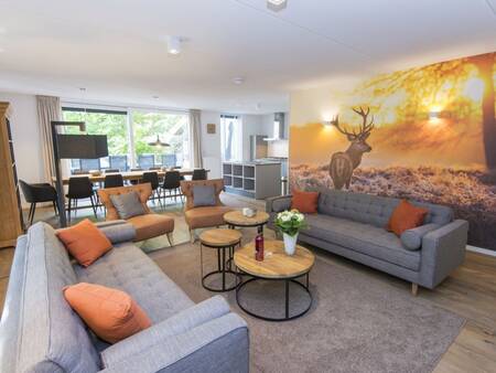 Living room with sitting area and dining area of a holiday home at Landal Miggelenberg holiday park