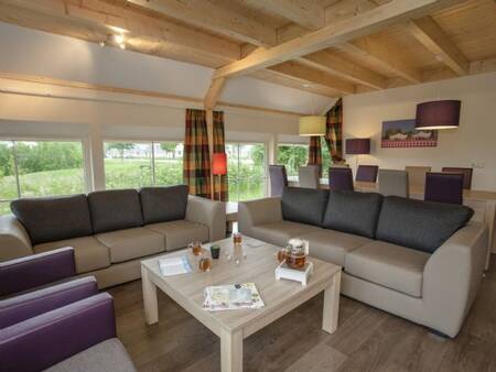 Living room with dining table of a holiday home at Landal Orveltermarke holiday park