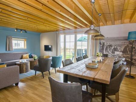 Long dining table in a holiday home at Landal Orveltermarke holiday park