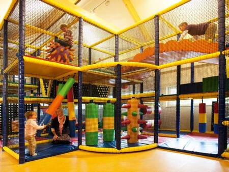 Children play in the indoor playground of Landal Orveltermarke