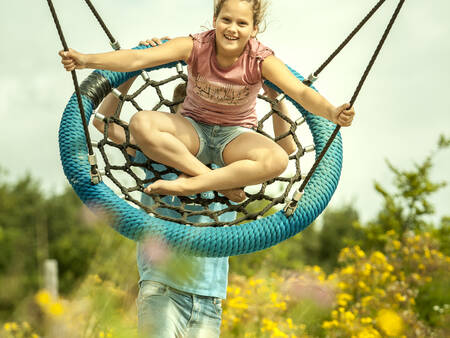 A child swings on a swing in a playground at the Landal Orveltermarke holiday park