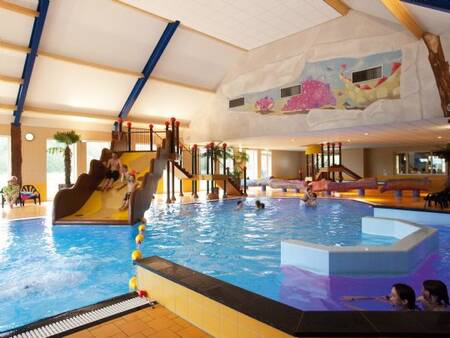 The indoor pool with a wide slide at the Landal Orveltermarke holiday park