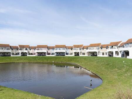 Holiday homes around a pond at the Landal Port Greve holiday park