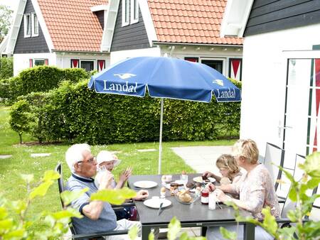 Garden with a terrace of a holiday home at Landal Resort Haamstede holiday park