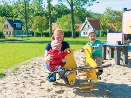 Children play in a playground at holiday park Landal Resort Haamstede