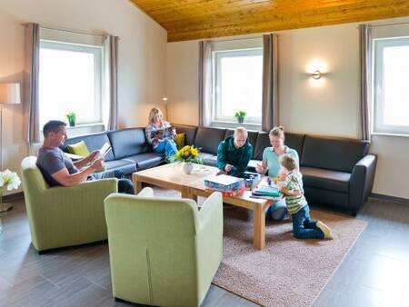 Living room with family in a holiday home at the Landal Salztal Paradies holiday park