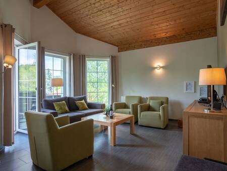 Living room with patio doors of a holiday home at the Landal Salztal Paradies holiday park