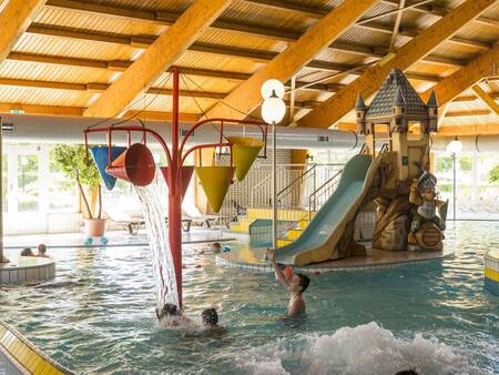 The indoor pool with slide and play equipment at the Landal Sonnenberg holiday park