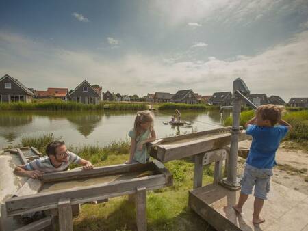 A family plays in the water playground at the Landal Strand Resort Nieuwvliet-Bad holiday park