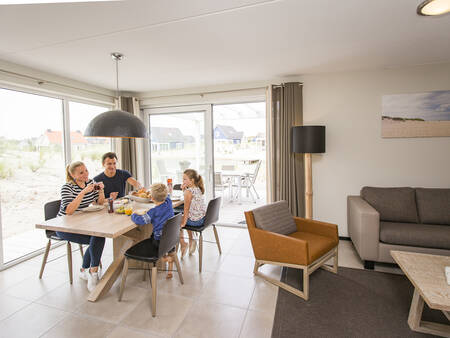 Living room and dining area of a holiday home at Landal Strand Resort Ouddorp Duin holiday park