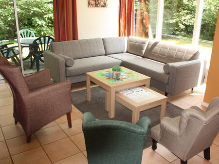 Seating area of a holiday home at Landal Stroombroek holiday park