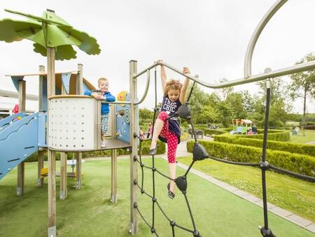 Children climb in a playground at holiday park Landal Villapark Livingstone