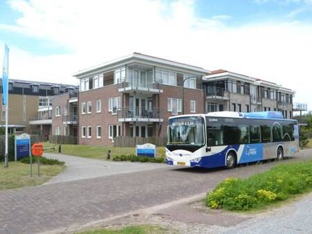 A bus in front of the apartment complex Landal Vitamaris