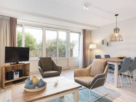 Living room and dining table of an apartment at Landal Vitamaris