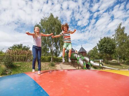 Children jump on the air trampoline in the playground at the Landal Warsberg holiday park