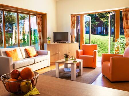 Living room with French doors of a holiday home at the Landal Waterpark Marina Lipno holiday park