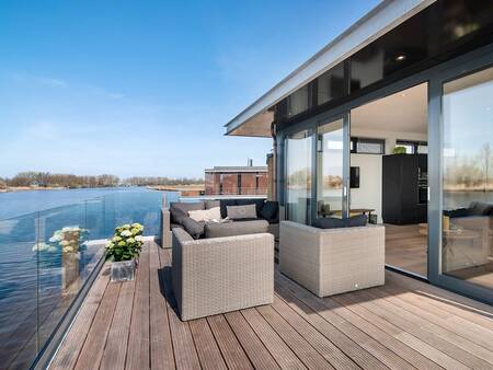 Terrace on the water of a holiday home at the Landal Waterpark De Alde Feanen holiday park