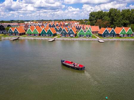 Aerial view of a sloop on the Markermeer in front of holiday park Landal Waterpark Volendam