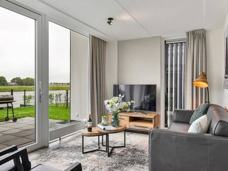 Living room with a view over the water at the Landal Waterresort Blocksyl holiday park