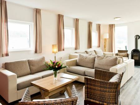 Cozy living room with stove of a holiday home at Landal Winterberg holiday park