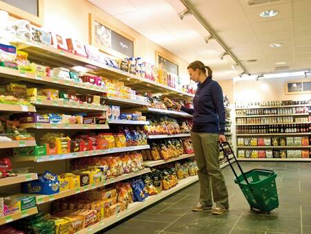 Woman does shopping in the supermarket of holiday park Landal Winterberg