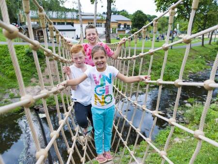 Children climb on the Low rope course at the Landal Wirfttal holiday park