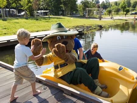 Bollo the bear and children in a pedal boat at the Landal Wirfttal holiday park
