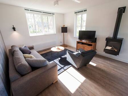 Living room with fireplace of a villa at Landal Holiday Villas De Waufsberg