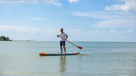 Man SUPing on the IJsselmeer at MarinaPark Beach Resort Soal
