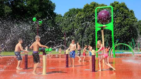 Children in the spray park in water play park "Splesj" at holiday park Molecaten Bosbad Hoeven