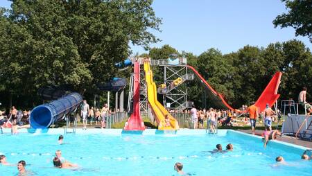Various large slides in the outdoor pool of holiday park Molecaten Bosbad Hoeven