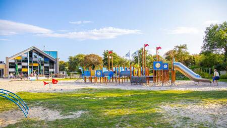 Large playground at the center building of holiday park Molecaten Hoogduin