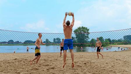 People playing volleyball on the beach of holiday park Molecaten Park De Agnietenberg