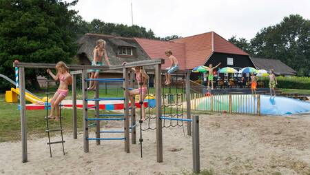 Children playing in the playground with air trampoline at Molecaten Park De Agnietenberg
