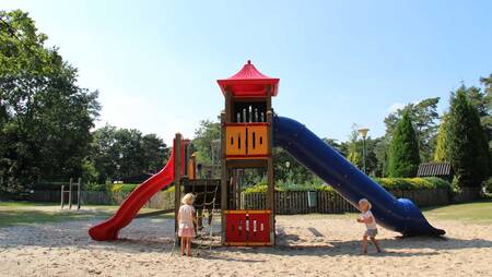 Children playing in a playground at holiday park Molecaten Park De Koerberg