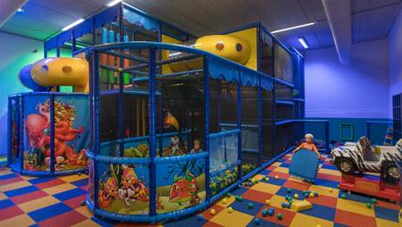 Children playing in the indoor playground of holiday park Molecaten Park Flevostrand