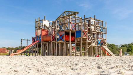 Children playing in a large playground at holiday park Molecaten Park Kuierpad