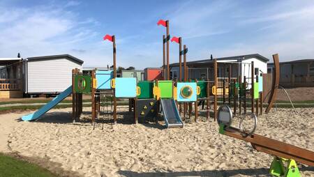 A playground between the chalets at holiday park Molecaten Park Noordduinen