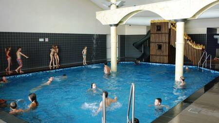 People swimming in the indoor pool of holiday park Molecaten Park Noordduinen