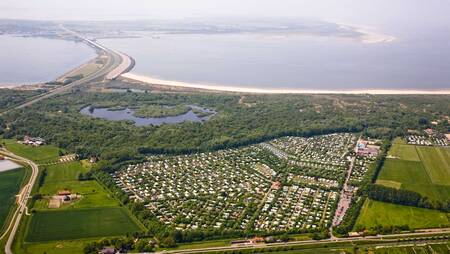 Aerial view of holiday park Molecaten Park Rondeweibos and the North Sea beach near Rockanje