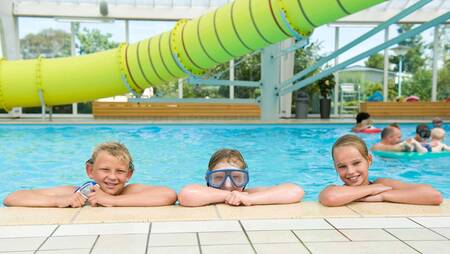 Children in the swimming pool with a 25-metre slide at the Molecaten Park Wijde Blick holiday park