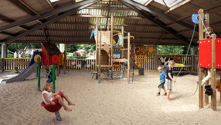 Children play in the indoor playground of holiday park Molecaten Park 't Hout
