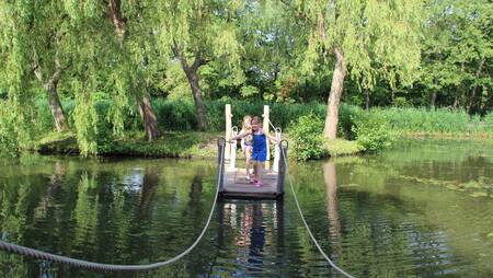 Children sail on a raft at holiday park Molecaten Waterbos