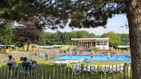 The outdoor pool with sunbathing area at holiday park Molecaten Waterbos
