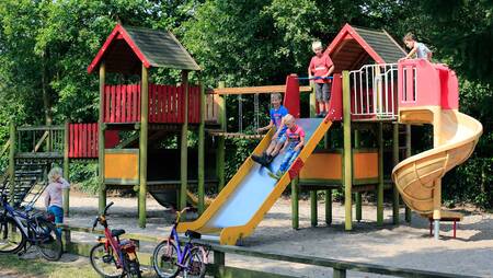 Children playing in a playground at holiday park Molecaten het Landschap